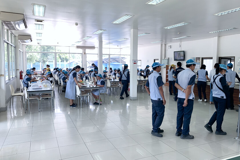 People eating in the Thailand factory cafeteria