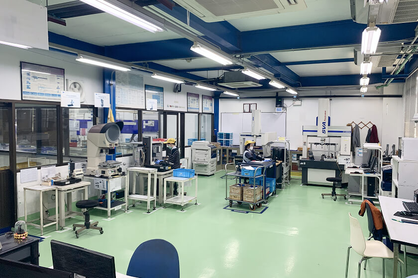 Employee working in the measuring room at the Thailand factory