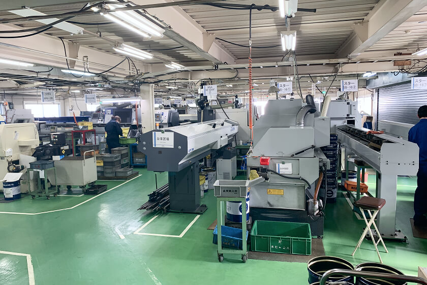 NC lathes and an operator on the head office factory floor