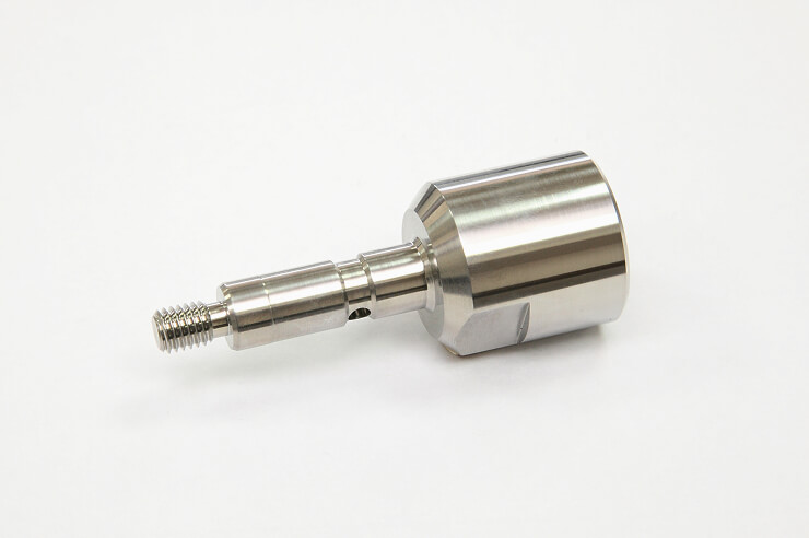 Metal part with a shaft machined on a multi-tasking lathe