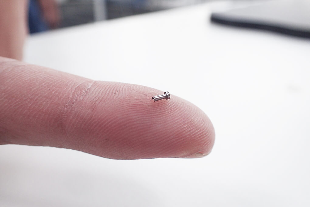 Small precision-cut part resting on a fingertip