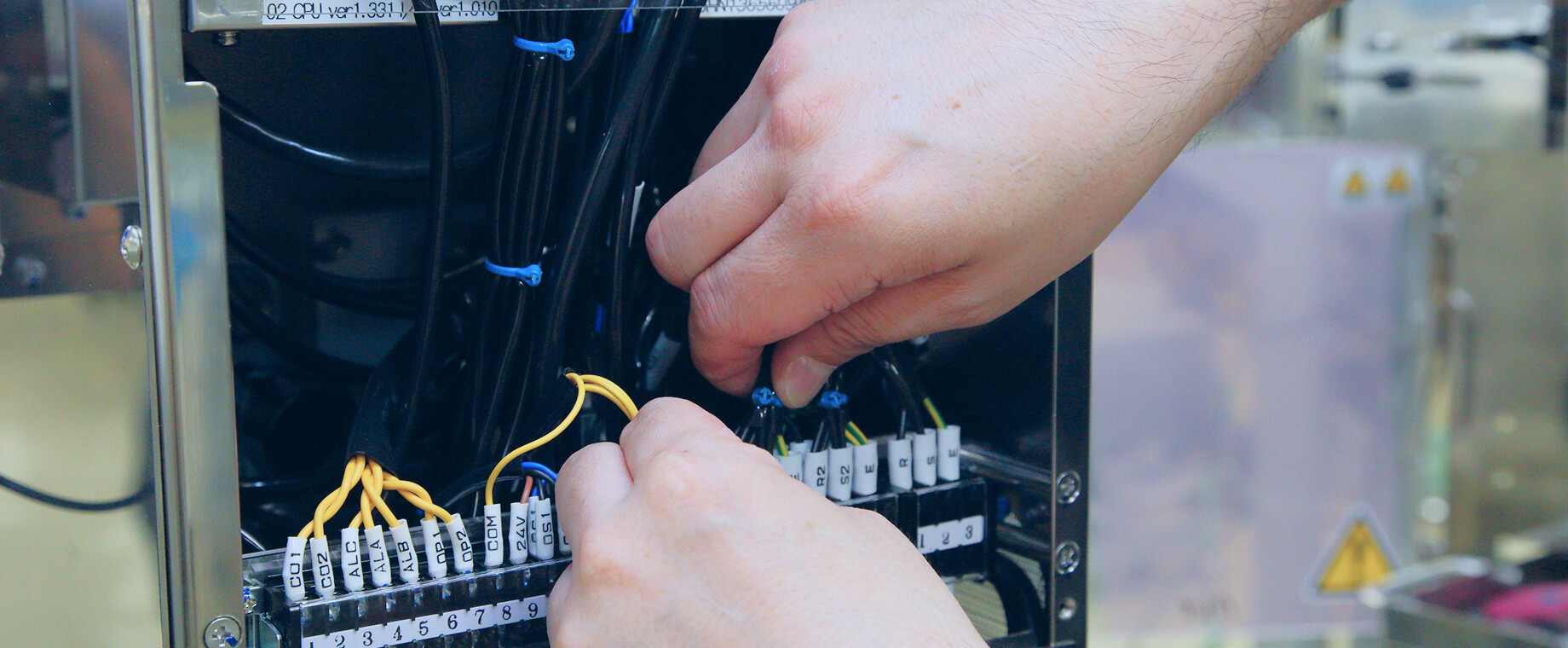 Close-up of hands assembling electrical wiring