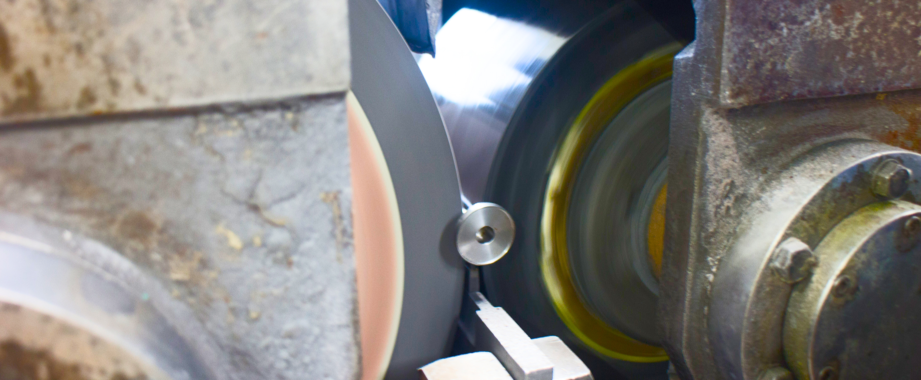 Grinding wheel rotating against a workpiece on a grinder